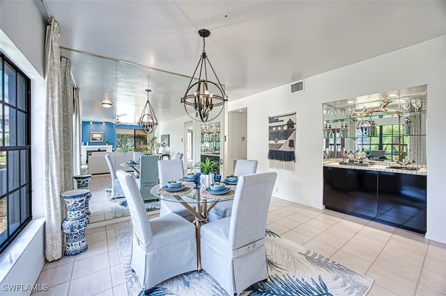 dining area with an inviting chandelier and light tile patterned floors