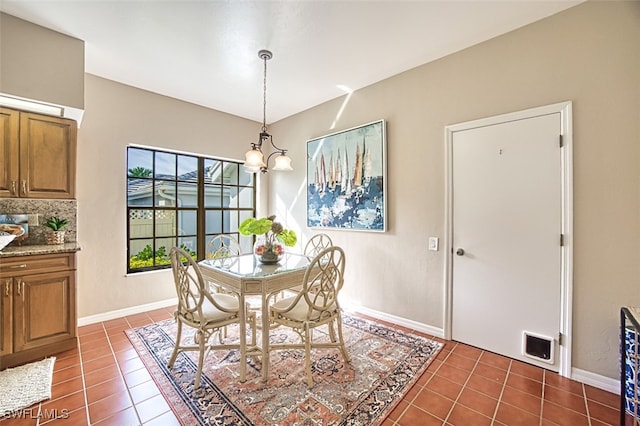 tiled dining space with a notable chandelier