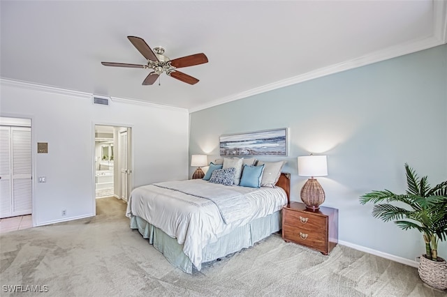 bedroom with crown molding, ensuite bath, light colored carpet, and ceiling fan