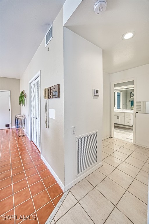 hallway with tile patterned flooring