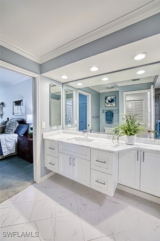 bathroom featuring ornamental molding and vanity