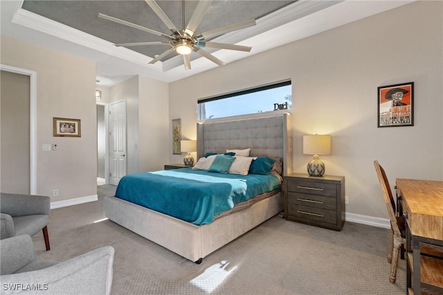 bedroom with light carpet, ceiling fan, a tray ceiling, and ornamental molding