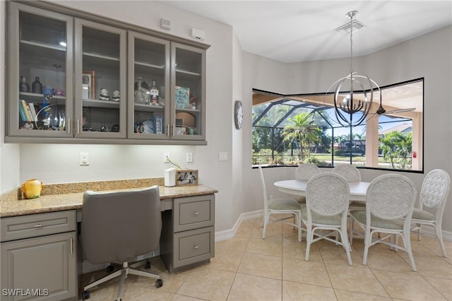 dining space with an inviting chandelier and light tile patterned flooring