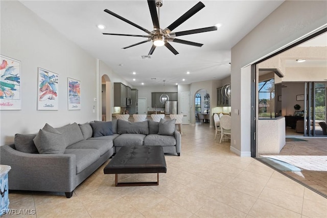 tiled living room with ceiling fan