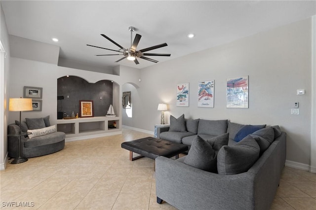 living room featuring ceiling fan and light tile patterned floors