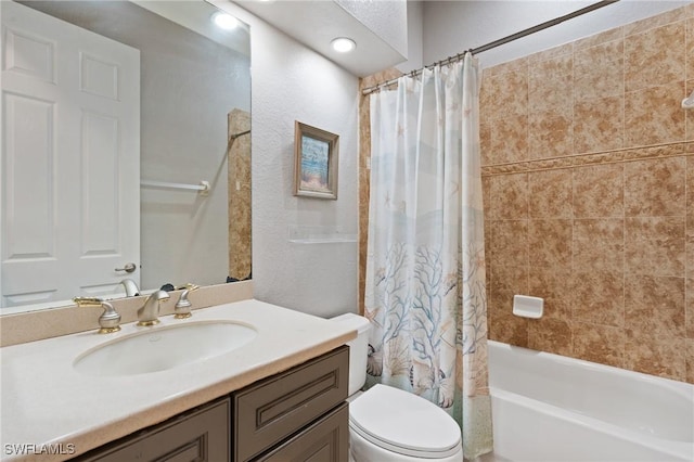 full bathroom with toilet, vanity, and shower / bath combo