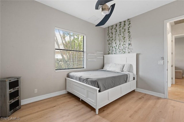 bedroom with ceiling fan and light wood-type flooring