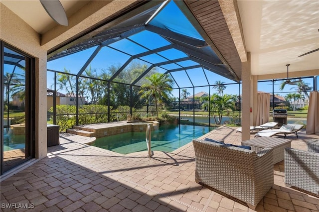 view of swimming pool with grilling area, a patio area, glass enclosure, and an in ground hot tub