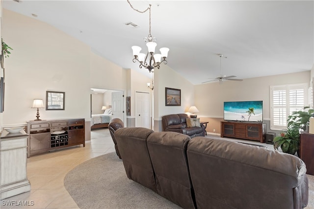 tiled living room with ceiling fan with notable chandelier and lofted ceiling