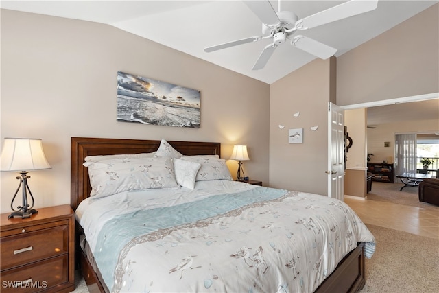 bedroom featuring light carpet, ceiling fan, and vaulted ceiling