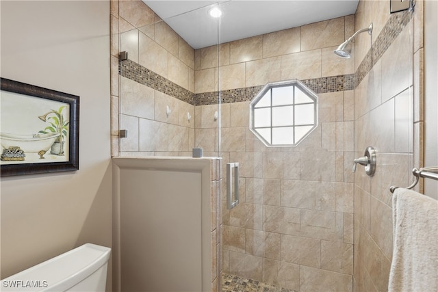 bathroom featuring toilet and walk in shower