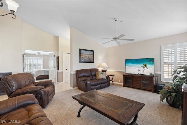 carpeted living room with ceiling fan and lofted ceiling