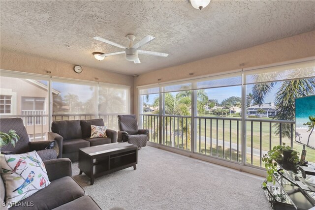 sunroom / solarium featuring ceiling fan