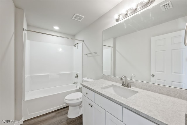 full bathroom featuring toilet, hardwood / wood-style floors, vanity, and washtub / shower combination