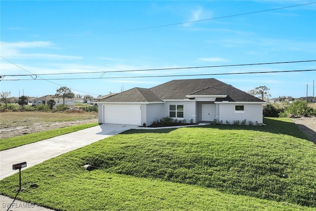 view of front of home with a front yard and a garage