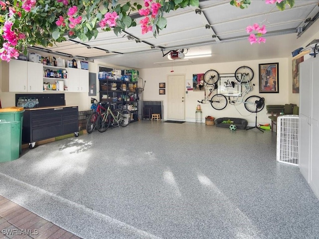 garage with electric panel and a garage door opener