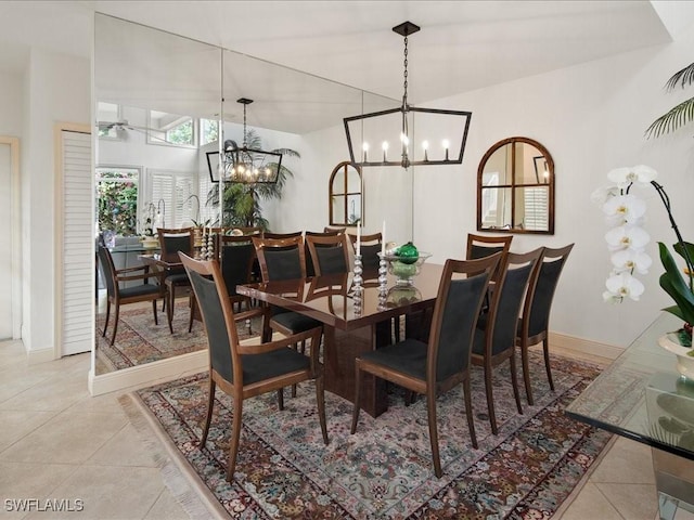 tiled dining space featuring ceiling fan with notable chandelier