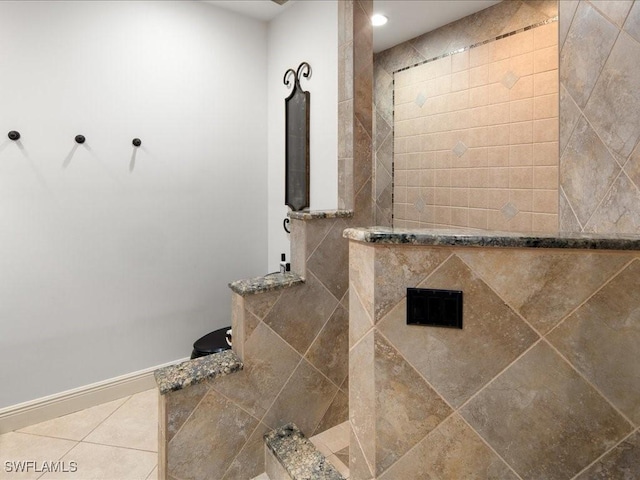 bathroom with tile patterned floors and tiled shower