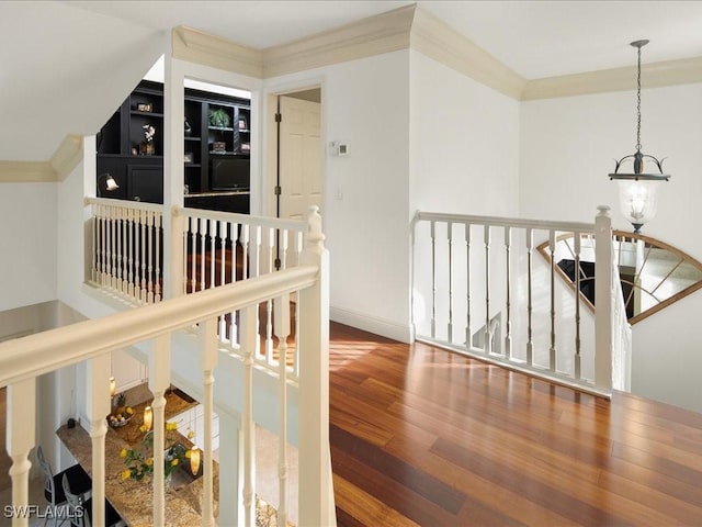 hall with ornamental molding and hardwood / wood-style flooring