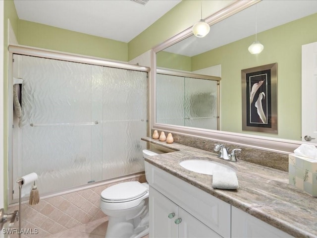 full bathroom with vanity, toilet, and shower / bath combination with glass door