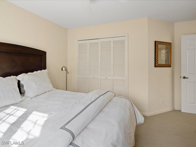 bedroom featuring light carpet and a closet