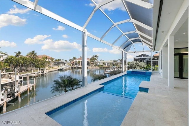 view of pool featuring glass enclosure, a patio area, an in ground hot tub, a boat dock, and a water view