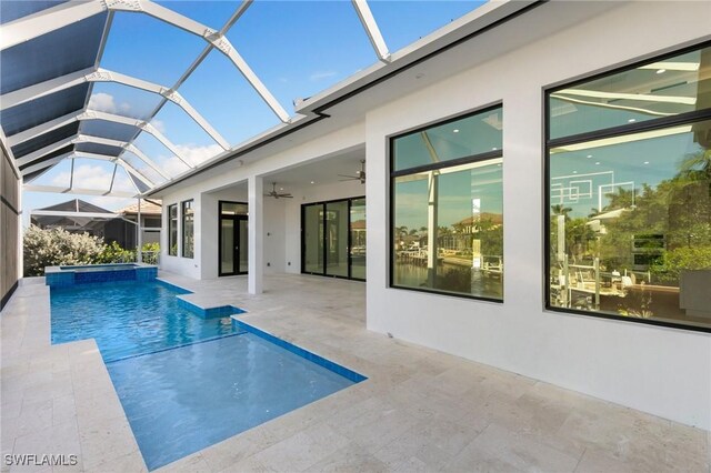 view of pool with ceiling fan, a patio, and glass enclosure