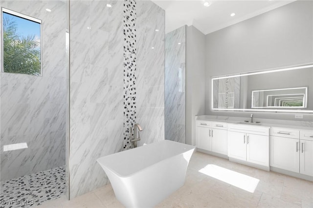 full bath featuring vanity, a freestanding tub, and a marble finish shower