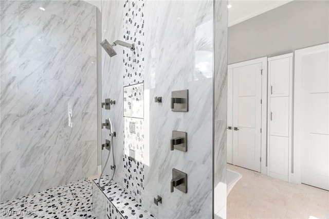 bathroom with a walk in shower and ornamental molding