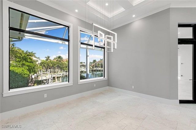 unfurnished room featuring a water view and crown molding