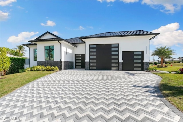 view of front facade with a front lawn and a garage