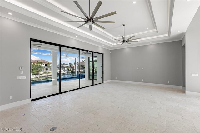 empty room with ceiling fan, crown molding, and a tray ceiling