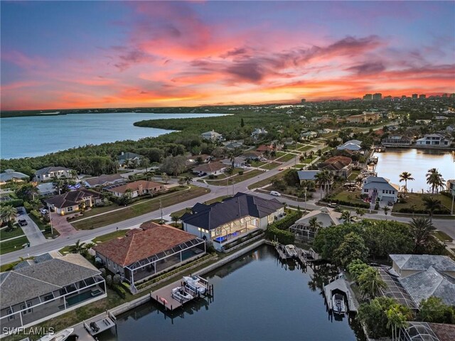 aerial view at dusk with a water view