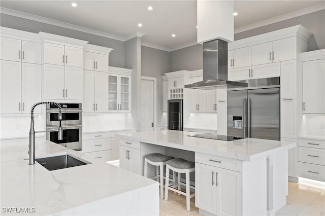 kitchen with a spacious island, a sink, stainless steel appliances, tasteful backsplash, and island range hood