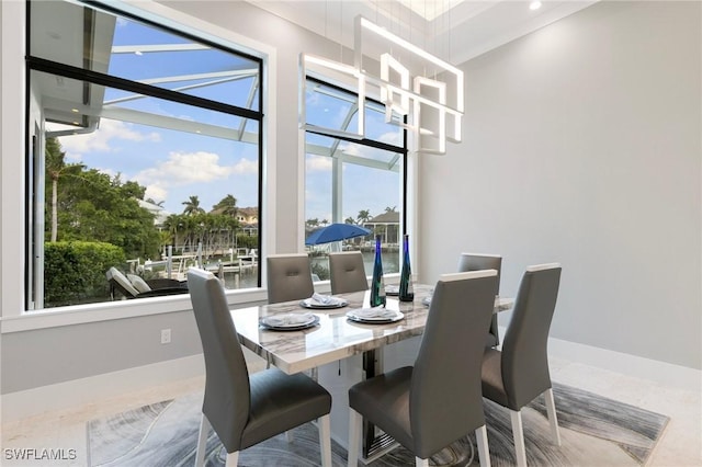 dining space with baseboards and an inviting chandelier