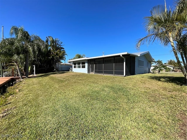 1712 Club House Rd, North Fort Myers, FL 33917 - back of house with a yard and a sunroom
