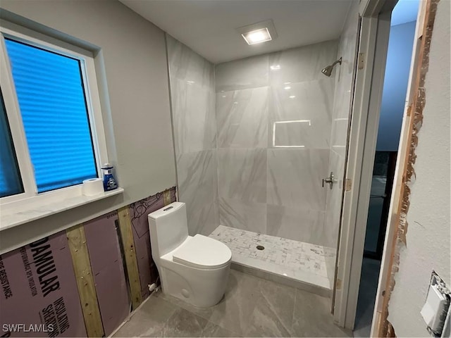 bathroom featuring toilet and walk in shower