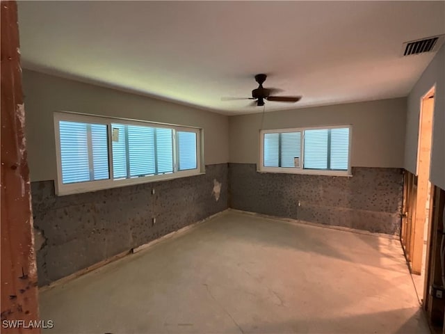 1712 Club House Rd, North Fort Myers, FL 33917 - empty room with ceiling fan, visible vents, and wainscoting