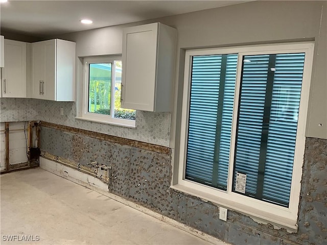 1712 Club House Rd, North Fort Myers, FL 33917 - kitchen featuring backsplash and white cabinets