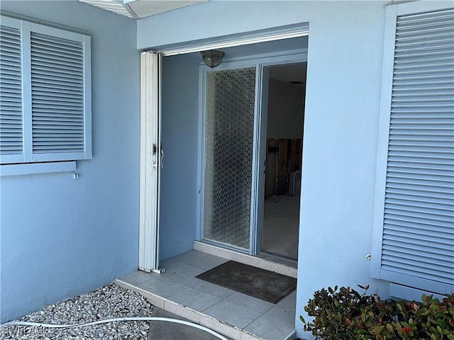 1712 Club House Rd, North Fort Myers, FL 33917 - doorway to property with stucco siding