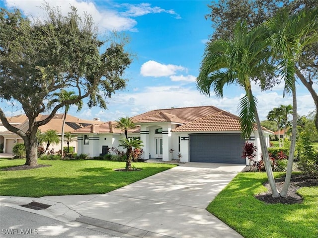 mediterranean / spanish-style house with a front yard and a garage