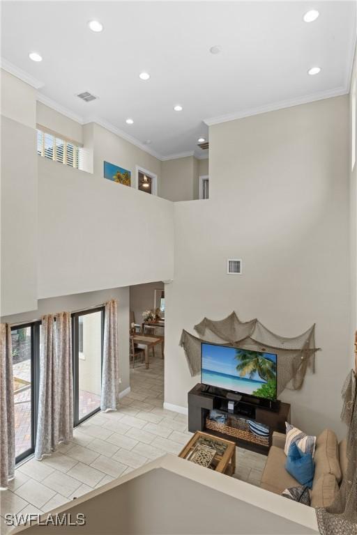 living room featuring ornamental molding and light tile patterned floors