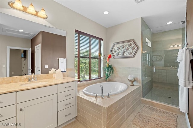 bathroom with vanity and independent shower and bath