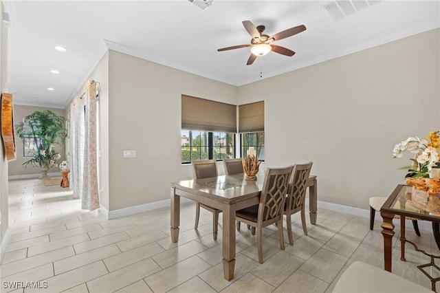 dining area with ornamental molding and ceiling fan