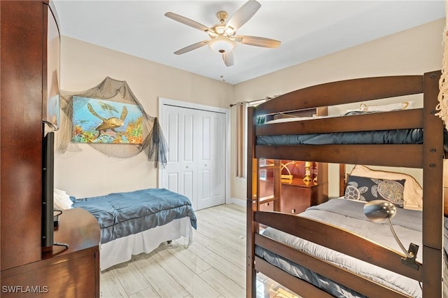 bedroom featuring ceiling fan, a closet, and light hardwood / wood-style flooring