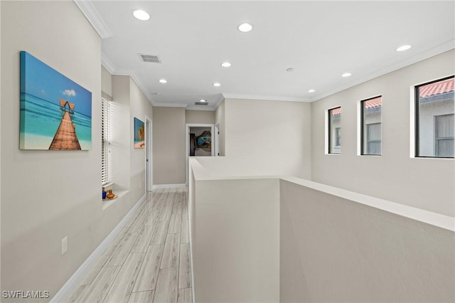 corridor featuring crown molding and light hardwood / wood-style flooring