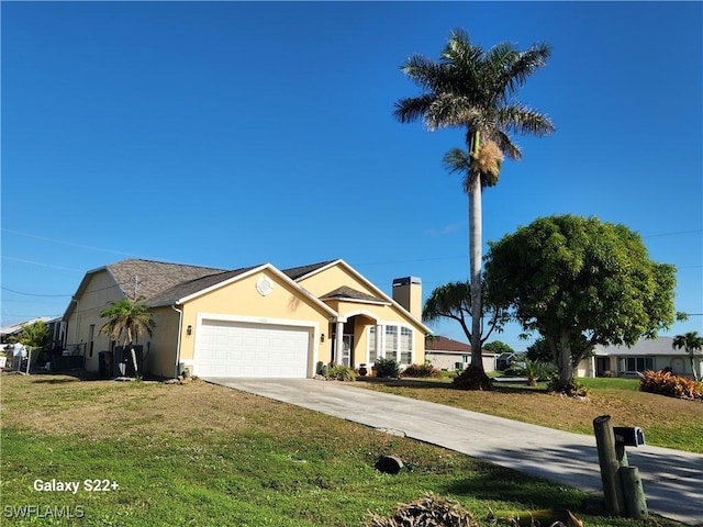 view of front of property with a garage and a front yard