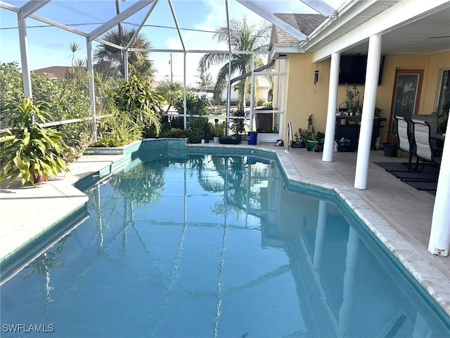 view of swimming pool with a patio area and glass enclosure