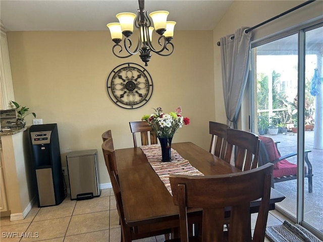 tiled dining area featuring an inviting chandelier