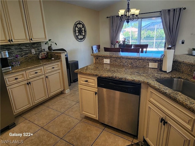 kitchen with pendant lighting, light stone countertops, light tile patterned flooring, decorative backsplash, and stainless steel dishwasher